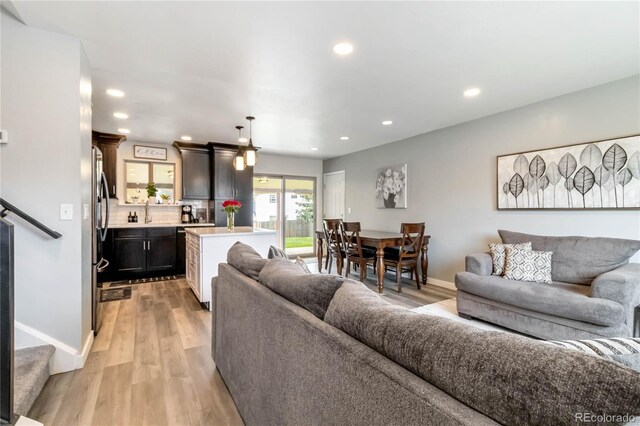10550 Routt St, Westminster, CO 80021 - living room with recessed lighting, baseboards, and light wood-style floors