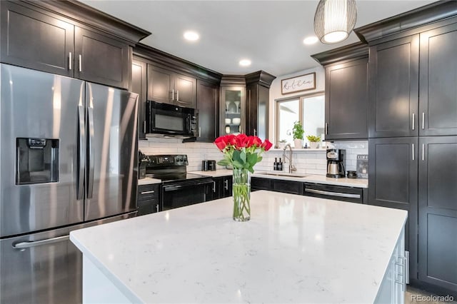 10550 Routt St, Westminster, CO 80021 - kitchen with a sink, black appliances, hanging light fixtures, and tasteful backsplash
