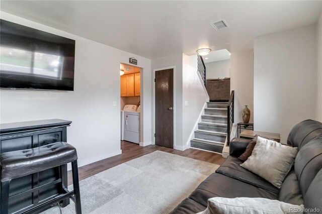 10550 Routt St, Westminster, CO 80021 - living area with separate washer and dryer, stairs, baseboards, wood finished floors, and visible vents