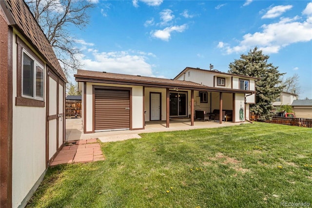 10550 Routt St, Westminster, CO 80021 - rear view of house featuring a yard, a patio, fence, and stucco siding