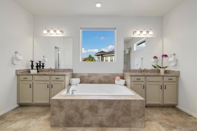 6692 S Robertsdale Way, Aurora, CO 80016 - bathroom featuring a bath, two vanities, and a shower