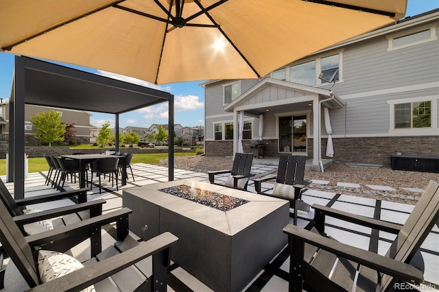 6692 S Robertsdale Way, Aurora, CO 80016 - view of patio / terrace with an outdoor fire pit, outdoor dining area, and a residential view