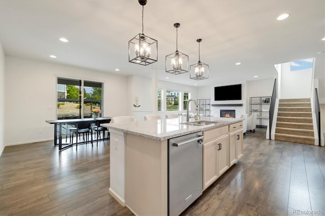6692 S Robertsdale Way, Aurora, CO 80016 - kitchen featuring stainless steel dishwasher, plenty of natural light, recessed lighting, a glass covered fireplace, and open floor plan
