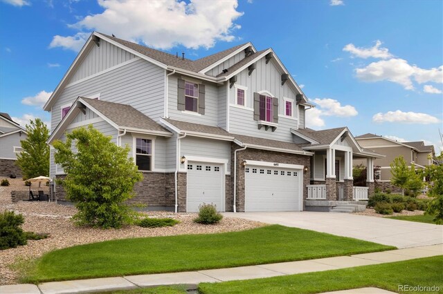 6692 S Robertsdale Way, Aurora, CO 80016 - craftsman inspired home with board and batten siding, a garage, a front lawn, a shingled roof, and concrete driveway