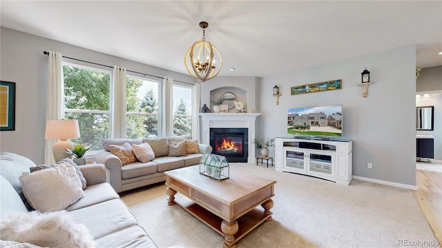 carpeted living room with an inviting chandelier