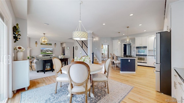 dining space with light hardwood / wood-style flooring