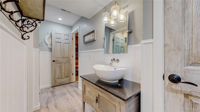 bathroom featuring hardwood / wood-style flooring and vanity