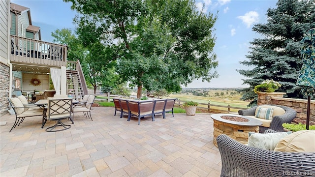 view of patio featuring an outdoor living space with a fire pit