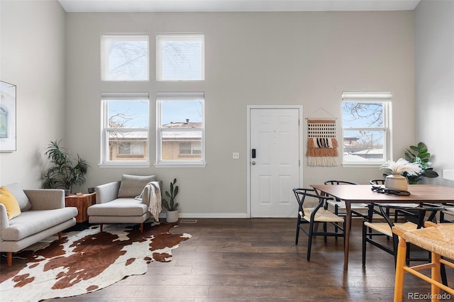 6450 W 44th Pl Unit B3, Wheat Ridge, CO 80033 - dining room featuring dark wood-type flooring, baseboards, and a high ceiling