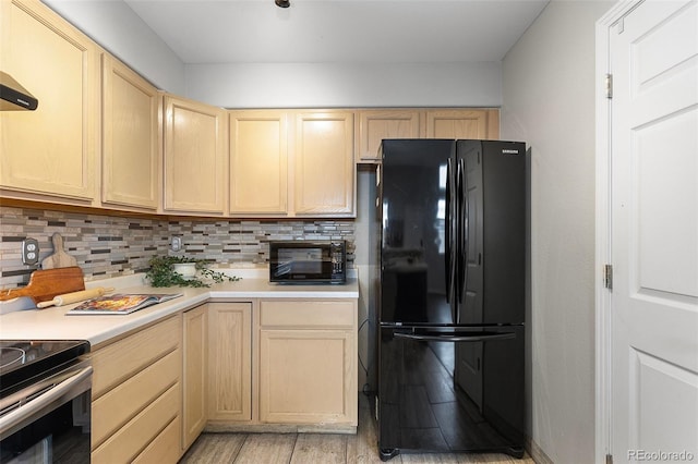 6450 W 44th Pl Unit B3, Wheat Ridge, CO 80033 - kitchen featuring black appliances, light brown cabinetry, and tasteful backsplash