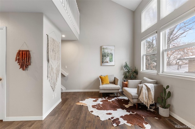 6450 W 44th Pl Unit B3, Wheat Ridge, CO 80033 - living area featuring baseboards, wood finished floors, and a high ceiling