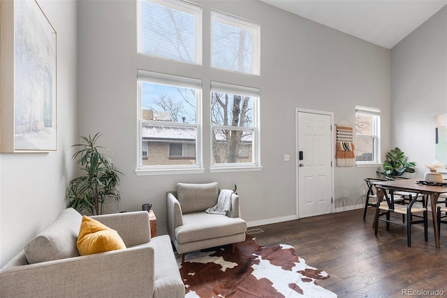 6450 W 44th Pl Unit B3, Wheat Ridge, CO 80033 - living area with high vaulted ceiling, dark wood-style flooring, plenty of natural light, and baseboards