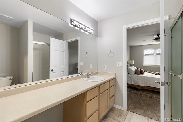 6450 W 44th Pl Unit B3, Wheat Ridge, CO 80033 - ensuite bathroom with a ceiling fan, a shower stall, vanity, toilet, and tile patterned floors