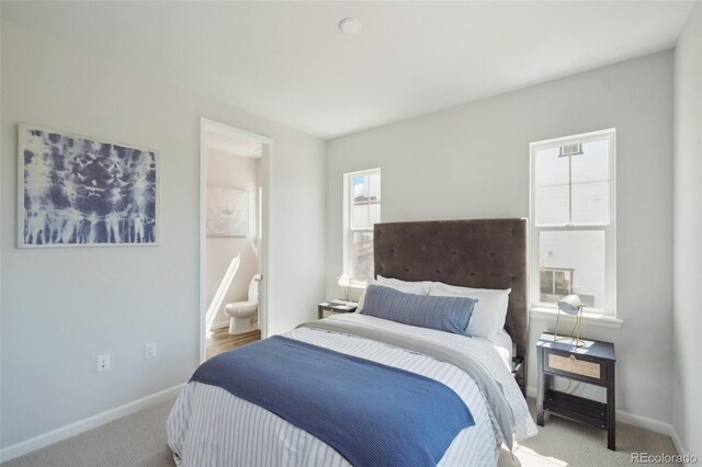 carpeted bedroom featuring ensuite bathroom