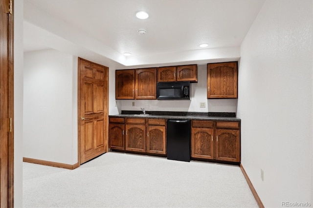 11144 Navajo St, Northglenn, CO 80234 - kitchen with black appliances, light colored carpet, dark countertops, and recessed lighting