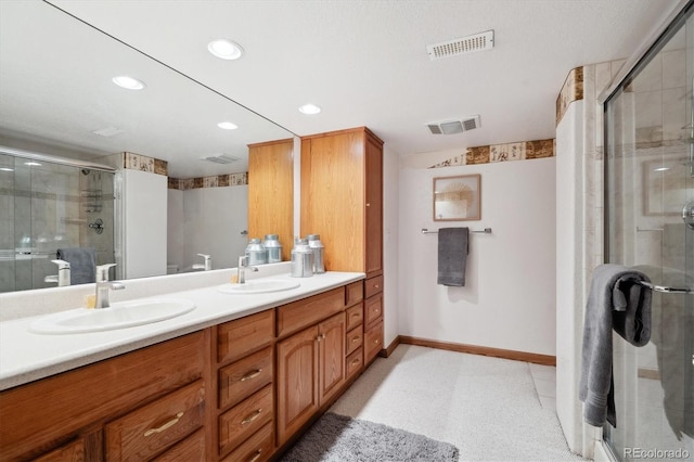 11144 Navajo St, Northglenn, CO 80234 - bathroom featuring double vanity, a shower stall, and recessed lighting