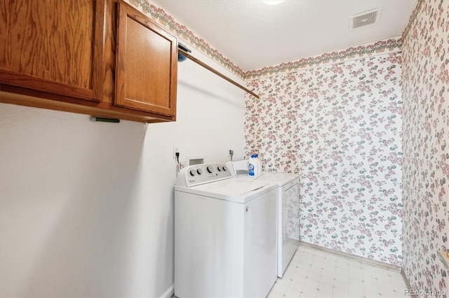 11144 Navajo St, Northglenn, CO 80234 - washroom featuring independent washer and dryer, cabinet space, wallpapered walls, and light flooring