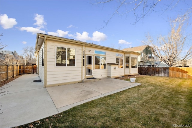 rear view of house with a patio area and a yard