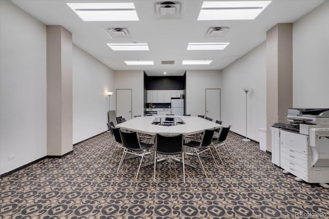 dining room with dark colored carpet and visible vents