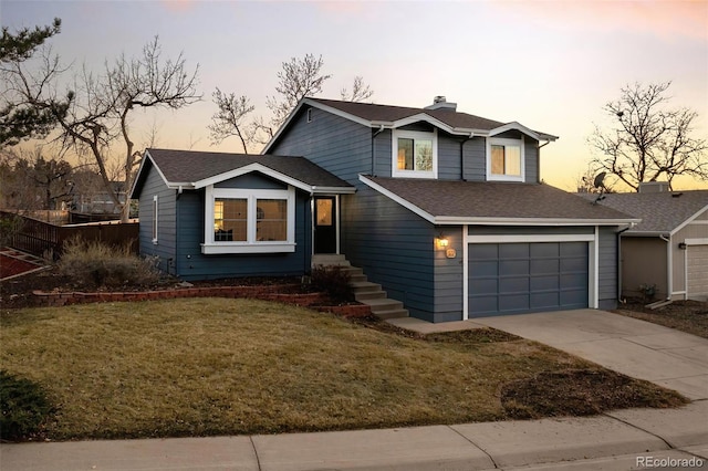 view of front facade featuring a shingled roof, a front yard, a chimney, a garage, and driveway