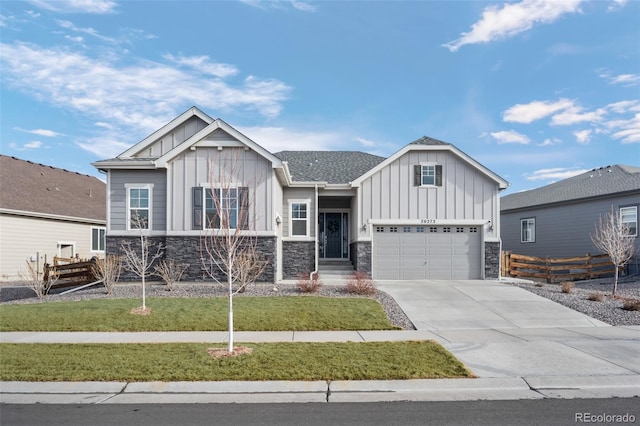 view of front of home featuring concrete driveway, board and batten siding, a front yard, and fence