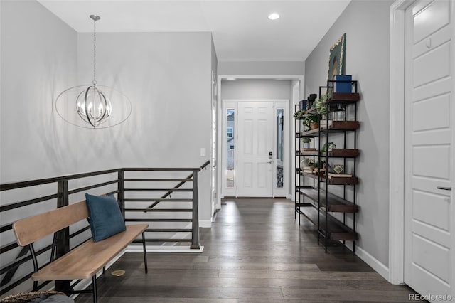 entrance foyer with baseboards, dark wood-style flooring, recessed lighting, and an inviting chandelier