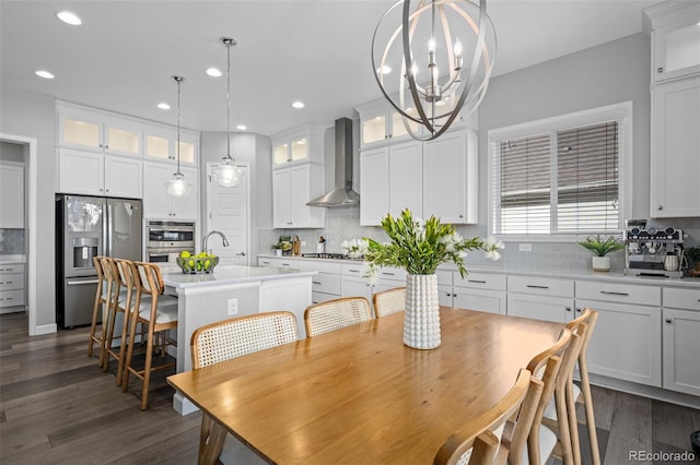 dining room with dark wood-style floors, a notable chandelier, and recessed lighting