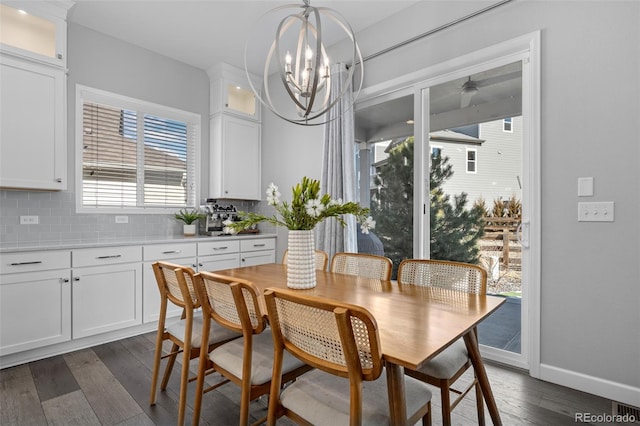 dining room with baseboards, dark wood-style flooring, and an inviting chandelier