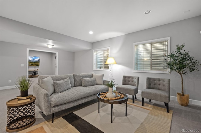 carpeted living room featuring baseboards and recessed lighting