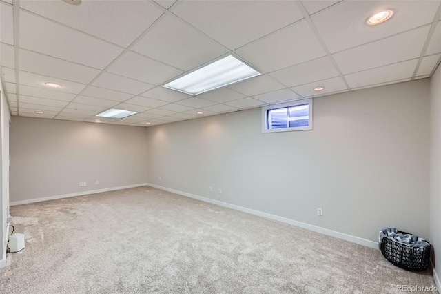 below grade area featuring carpet flooring, recessed lighting, a paneled ceiling, and baseboards