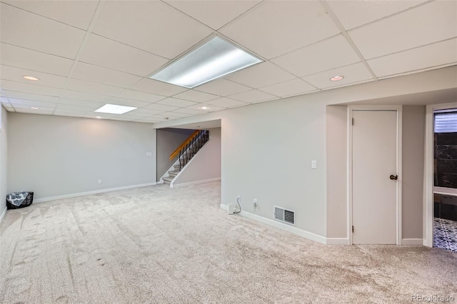 finished basement with visible vents, baseboards, stairway, carpet flooring, and recessed lighting