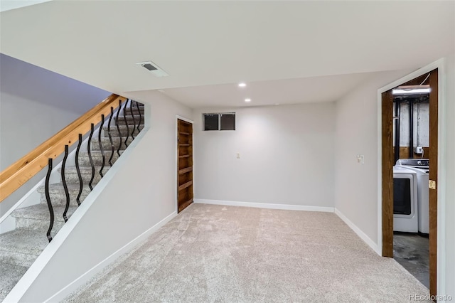 finished below grade area with visible vents, baseboards, stairs, carpet floors, and washer / clothes dryer