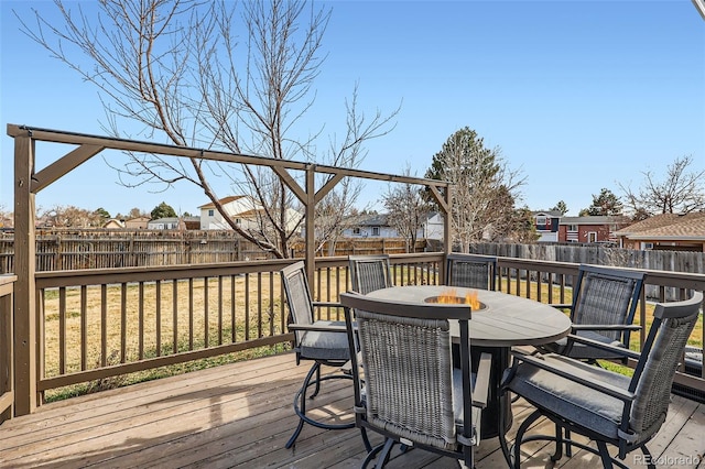 wooden deck with outdoor dining area, a residential view, and a fenced backyard