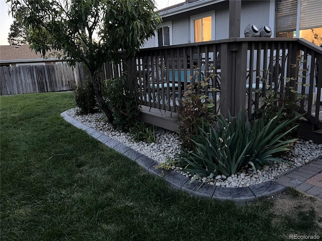 view of yard featuring a wooden deck and fence