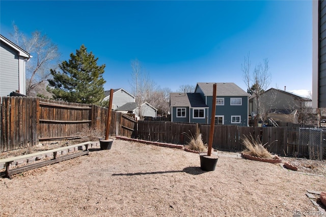 view of yard with a fenced backyard and a residential view