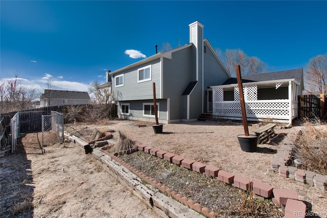 rear view of property featuring fence and a chimney