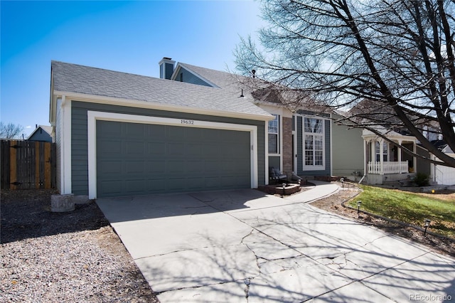 ranch-style home with an attached garage, a shingled roof, driveway, and fence