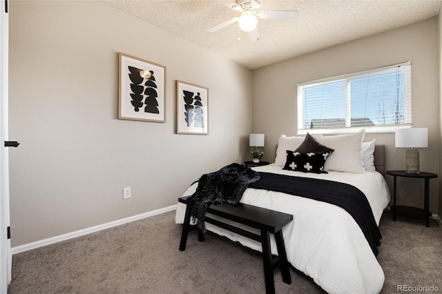 carpeted bedroom featuring a ceiling fan, baseboards, and a textured ceiling