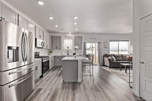 515 Bridger Ave, Fort Lupton, CO 80621 - kitchen with plenty of natural light, a kitchen bar, gray cabinets, and appliances with stainless steel finishes