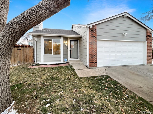 view of front of home with a front yard and a garage