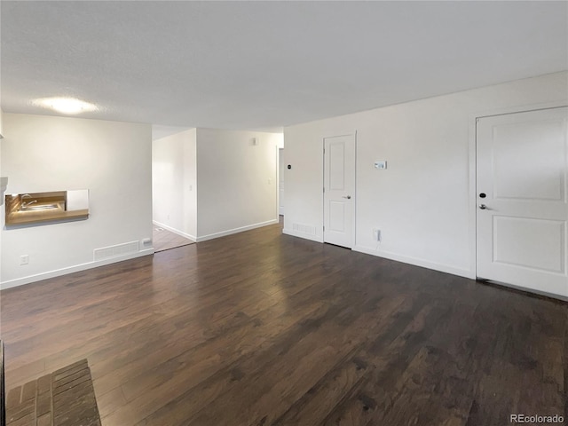 empty room featuring dark hardwood / wood-style flooring