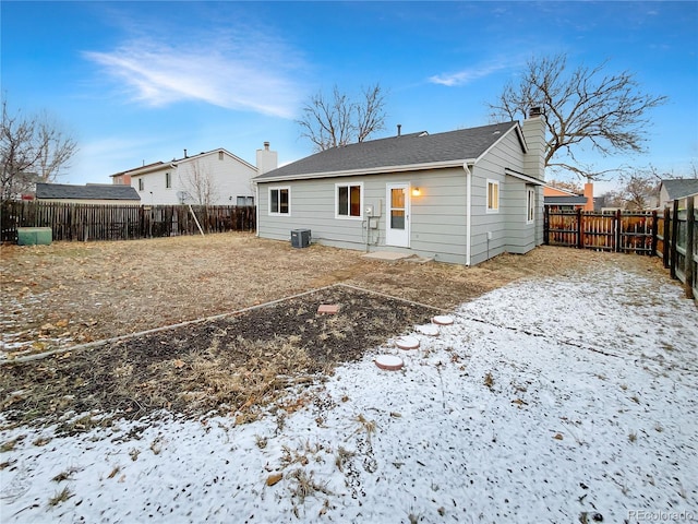 snow covered property with central air condition unit