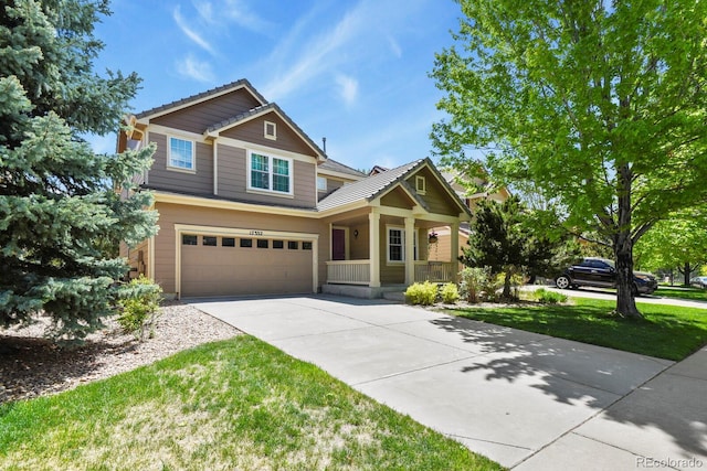 17332 E Lake Ln, Aurora, CO 80016 - craftsman house with covered porch, an attached garage, concrete driveway, and a front lawn