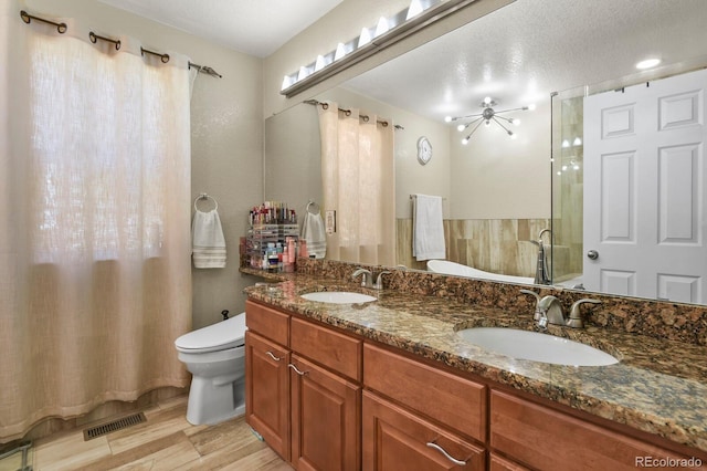 17332 E Lake Ln, Aurora, CO 80016 - full bath with toilet, double vanity, wood finished floors, a shower with shower curtain, and ceiling fan