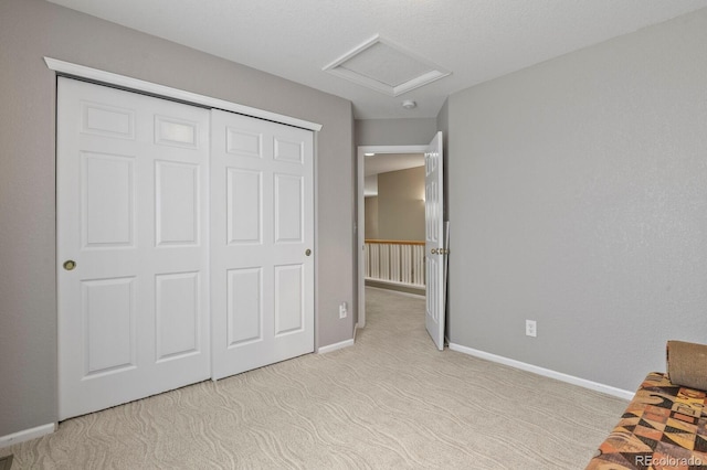 17332 E Lake Ln, Aurora, CO 80016 - unfurnished bedroom with attic access, carpet floors, baseboards, and a closet