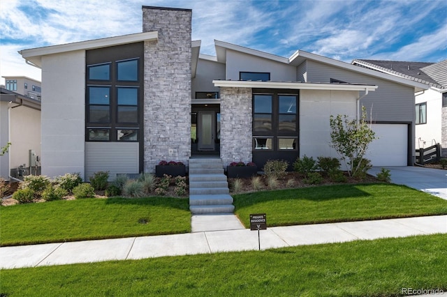 modern home featuring a garage and a front lawn