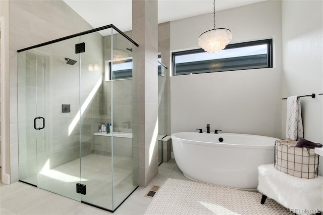 bathroom featuring separate shower and tub, tile patterned flooring, and a notable chandelier