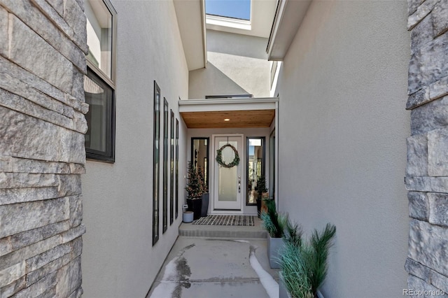 view of exterior entry with stucco siding