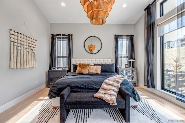 bedroom with light wood-style floors, multiple windows, baseboards, and recessed lighting