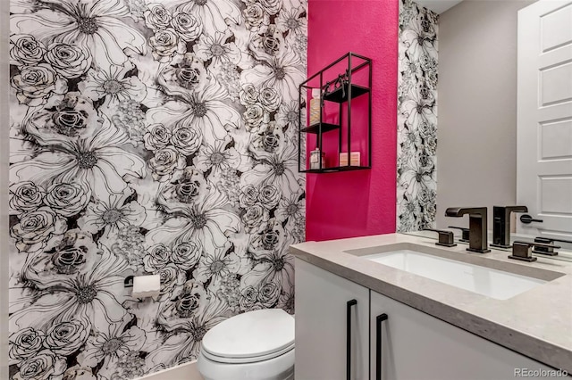 bathroom featuring vanity and toilet